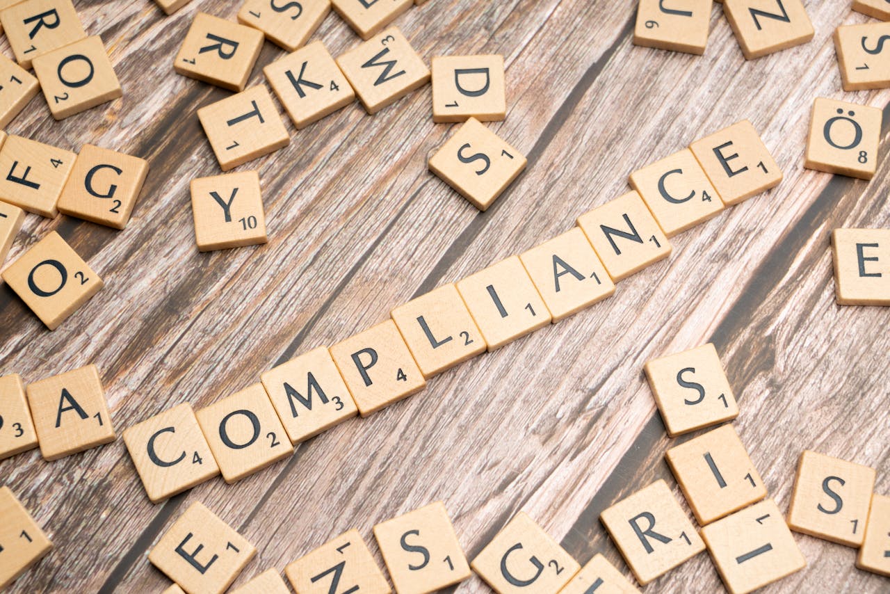 The Art of Drawing Readers In: Your attractive post title goes here Wooden letter tiles forming the word 'COMPLIANCE' on a rustic wooden background.